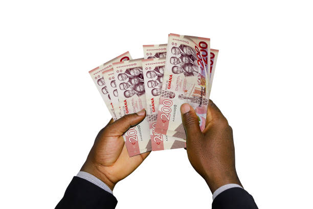 istock Black Hands in suit holding 3D rendered Ghanaian cedi notes 1369041747