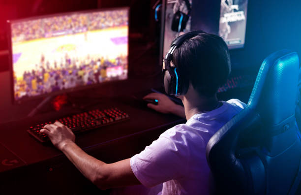 istock Rearview shot of a young man playing computer games 1369043691