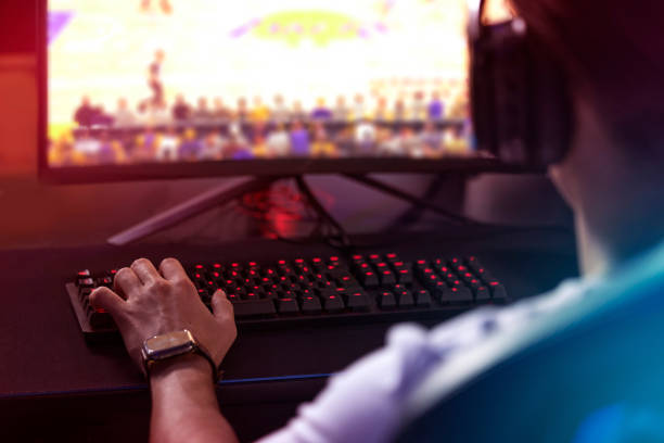 istock Rearview shot of a young man playing computer games 1369043761