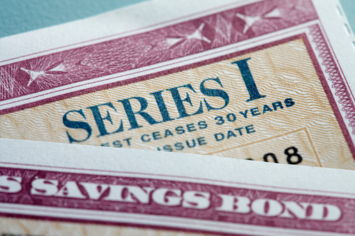 A close up of two U.S. government Series I Bonds stacked on top of each other.