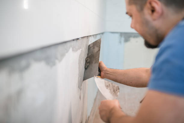istock Close-up of worker gluing ceramic tiles 1369052789