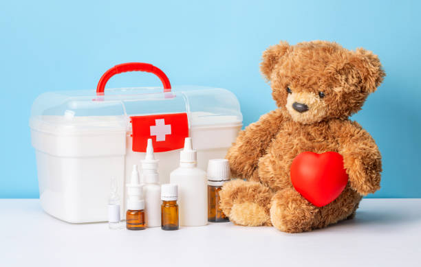istock Teddy bear and first aid kit with medicines and pills 1369055829