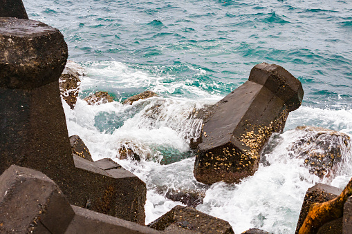 The seaside breakwater is constantly washed by the sea
