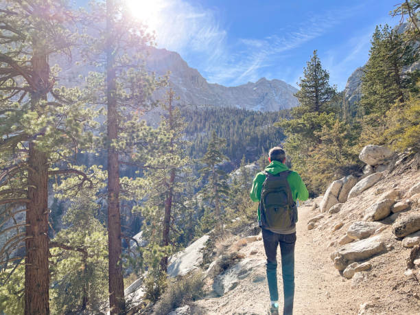 istock Man hiking Mount Whitney, California. Hiking path and mountain view 1369059275