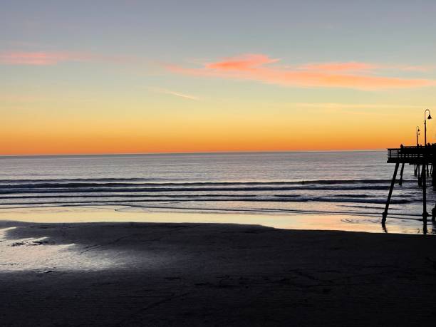 istock People relaxing on the beach at sunset 1369059444