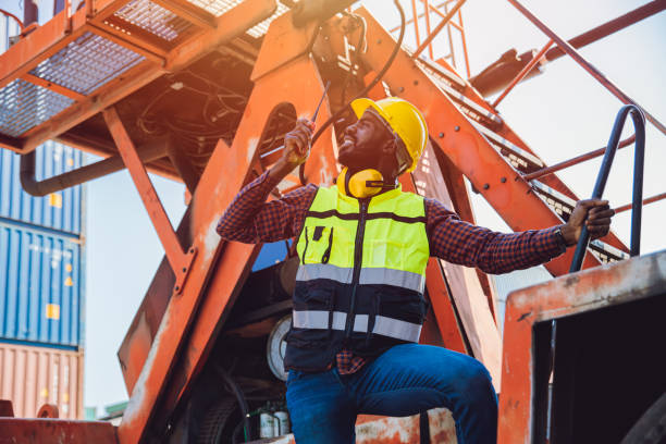 istock Black African male worker work as port cargo manager using radio control loading container in logistic industry. 1369061462