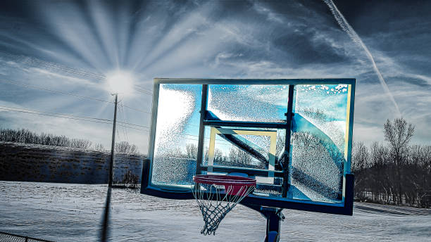 Basketball hoop with red rim and net covered in fresh white snow
