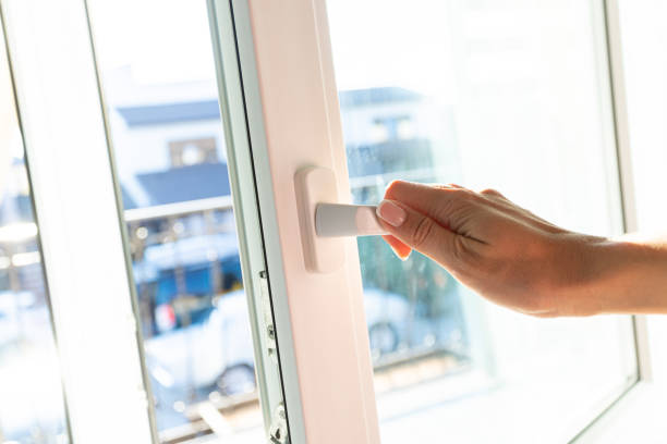 istock Young woman opens white window with sunlight at home. 1369064549