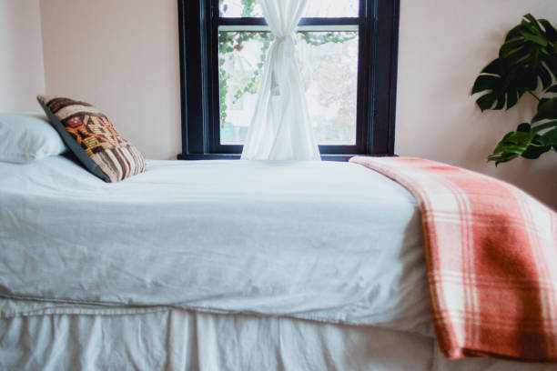 a neatly made bed in a cute bedroom of a Portland Oregon house.