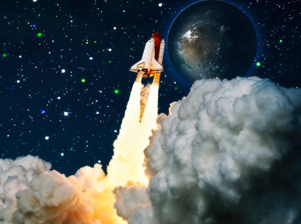 istock shuttle launch in the clouds to outer space. Dark space with stars on background.Spaceship flight. Elements of this image furnished by NASA 1369066275