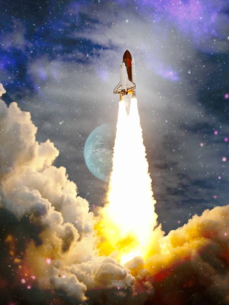 istock shuttle launch in the clouds to outer space. Dark space with stars on background.Spaceship flight. Elements of this image furnished by NASA 1369066310