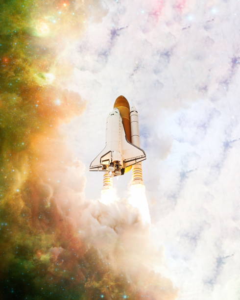 istock shuttle launch in the clouds to outer space. Dark space with stars on background.Spaceship flight. Elements of this image furnished by NASA 1369066322
