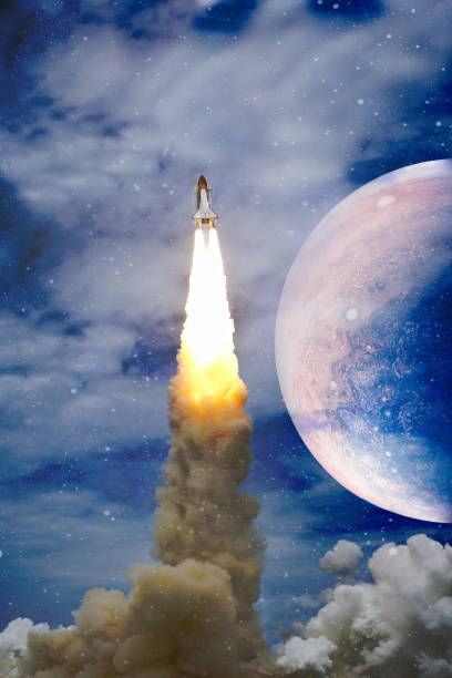 istock shuttle launch in the clouds to outer space. Dark space with stars on background.Spaceship flight. Elements of this image furnished by NASA 1369066333