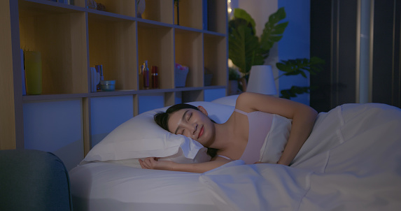 asian woman sleeps well in bedroom at night