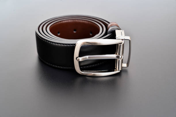 istock Double-sided black and brown leather belt with an unbuttoned buckle on a black. 1369068752
