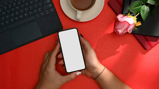 istock Top view image of hands holding an empty screen smartphone mockup 1369070662