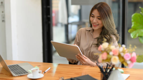 istock Young entrepreneur woman using her digital tablet. 1369070836