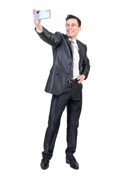 istock Positive businessman taking selfie on white background 1369071835
