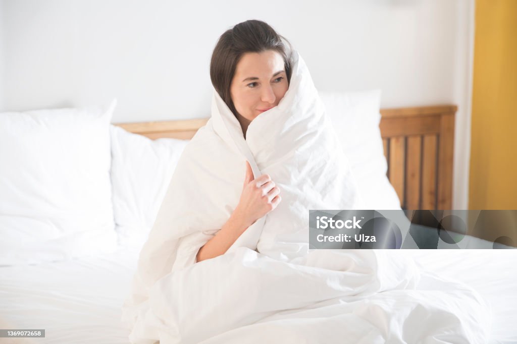 woman lying in bed under a blanket. insomnia. Healthy sleep. 35-39 Years Stock Photo