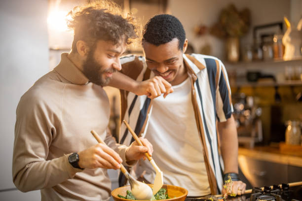 istock Two guys cooking healthy together at home 1369073157