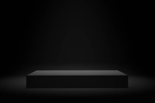 istock Blank black platform or pedestal with black background for product display. Empty stand for showing or presenting products. 1369075465