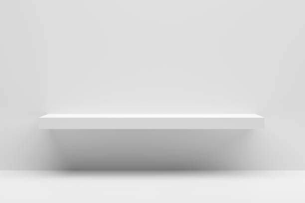 istock Front view of empty white shelf mounted on a white wall with white table showcase. 1369075591