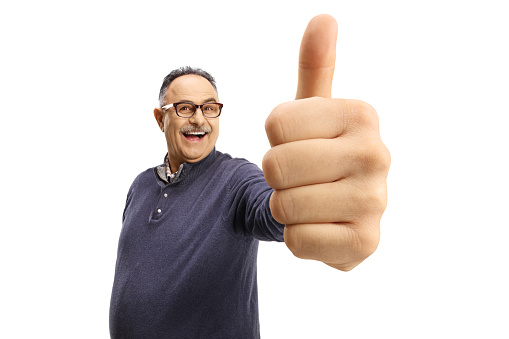 Happy mature casual man showing thumbs up in front of camera isolated on white background