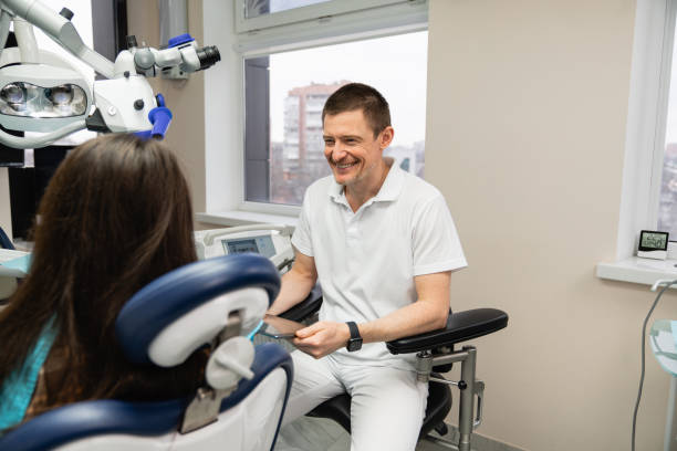 istock Dentist communicates with patient in dental office 1369076788