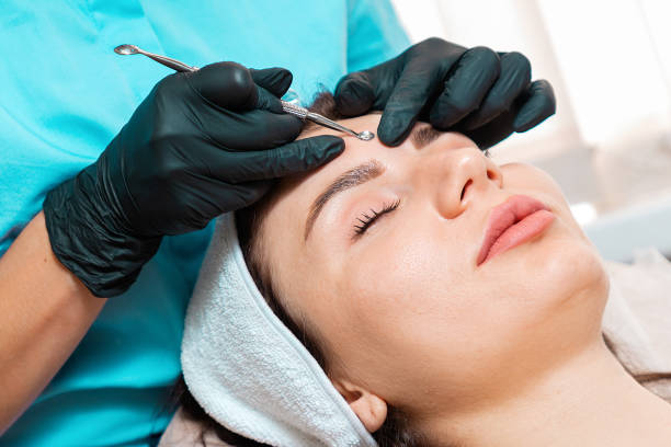 istock Salon cleansing beauty procedure. Cosmetologist in spa doing acne treatment using mechanical instrument. Close up of face. Concept of professional skin care 1369077728