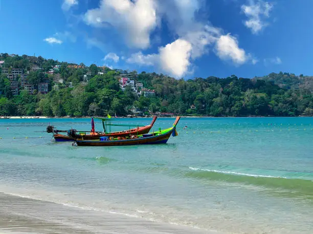 Blue Skies white Sandy Beach and turquoise waters of Patong Beach Phuket Thailand