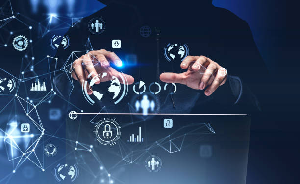 istock Front view of hacker in data room. Internet, innovation and cyber attack concept. Data protection hologram icons. Hands over laptop 1369079036