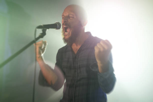 Rock singer screaming in a live show with stage lights