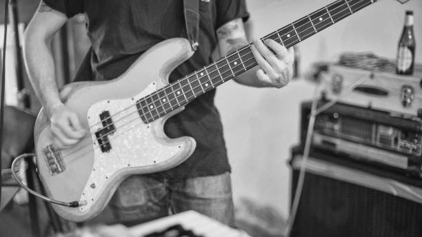 istock Band playing in their rehearsal studio: bass guitar player 1369079391