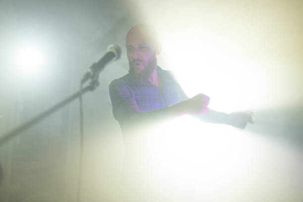 Rock singer screaming in a live show with stage lights