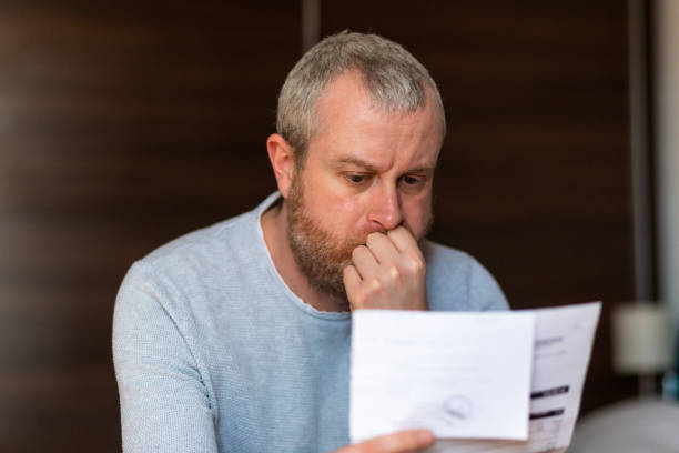 istock Worried man checking bills at home 1369079582