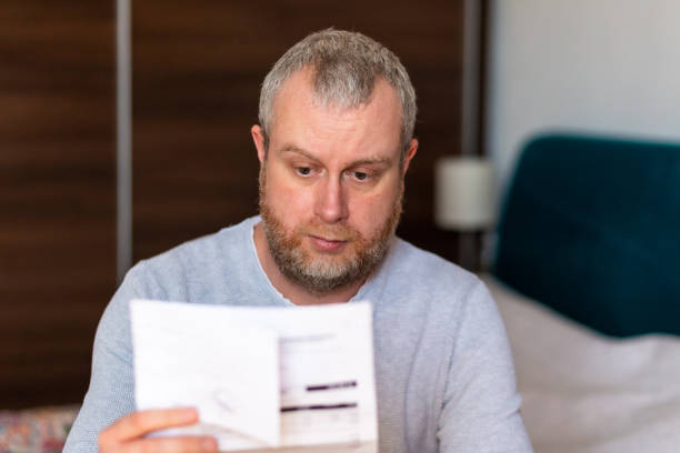 istock Worried man checking bills at home 1369079588