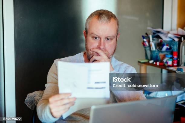 Worried Man Checking Bills At Home Stock Photo - Download Image Now - Energy Bill, Consumerism, Price