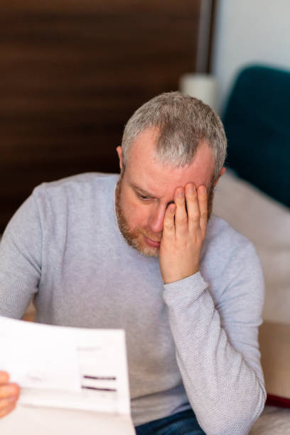 istock Worried man checking bills at home 1369079632