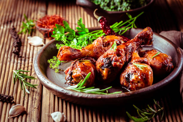 istock Marinated chicken drumsticks with baked potatoes and spinach 1369080360