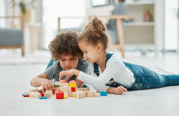 istock Shot of two siblings playing with building blocks 1369080772