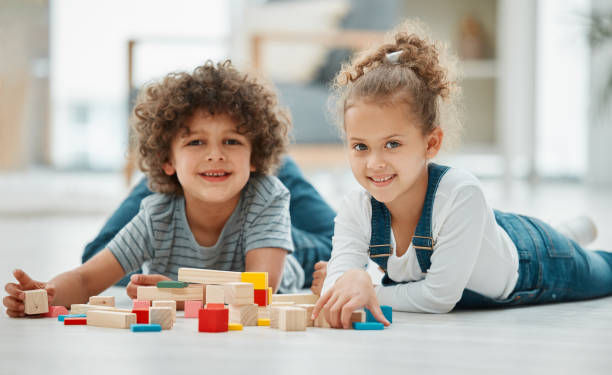 istock Shot of two siblings playing with building blocks 1369080773