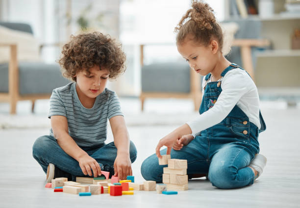 istock Shot of two siblings playing with building blocks 1369080776