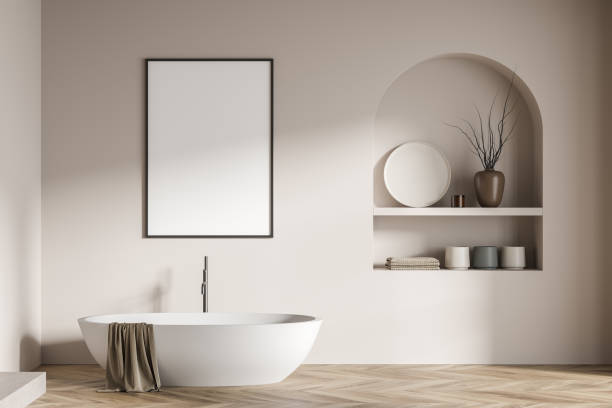 istock Modern bathroom interior with ceramic bathtub. White walls, hardwood flooring. Blank framed poster on wall. Mockup. 3d rendering. 1369080900