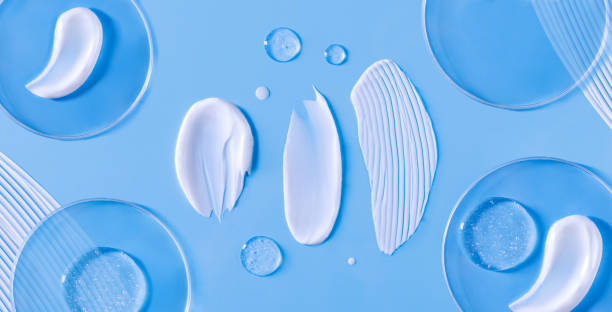 banner smears of cream round transparent drop of transparent gel serum in a petri dish on a blue background banner smears of cream round transparent drop of transparent gel serum in a petri dish on a blue background shower gel photos stock pictures, royalty-free photos & images