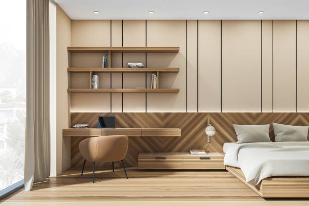 istock Light bedroom interior with bed, linens and workplace with window 1369081727
