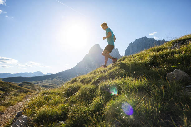 istock Young man trail running on the Dolomites mountain 1369081746