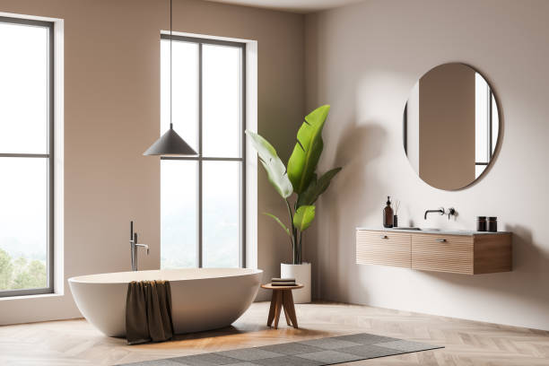 istock Light bathroom interior with sink and bathtub, decoration on deck and window 1369081763