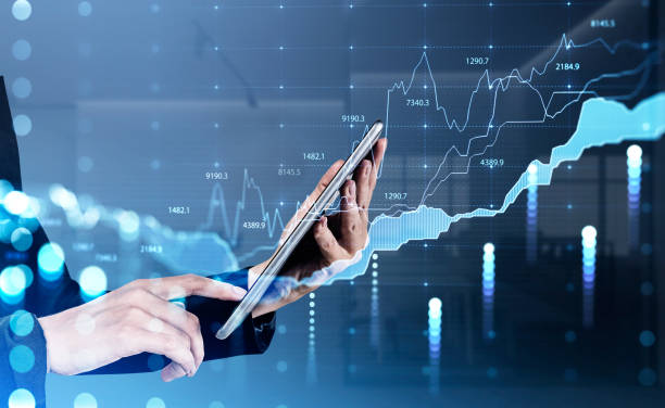 istock Businessman in formal suit is holding tablet and touching it 1369082276