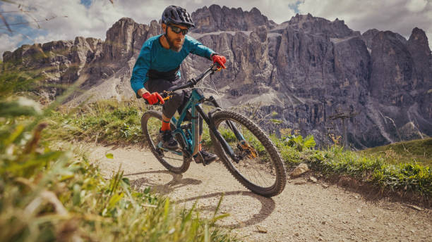 MTB mountain biking outdoor on the Dolomites:enduro discipline over a single trail track stock photo
