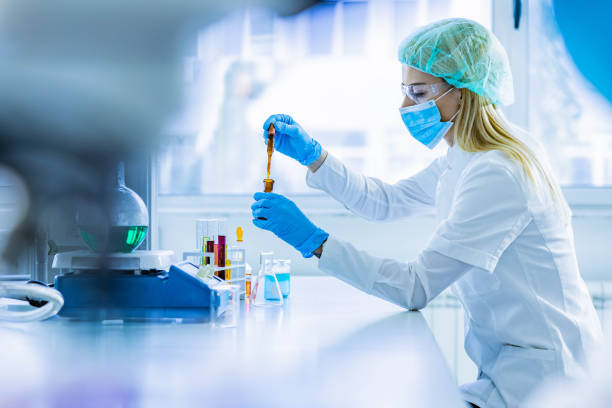 istock Young female chemist working with poisonous liquid in a laboratory. 1369083174